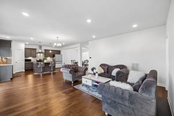 an empty room with windows and fireplace