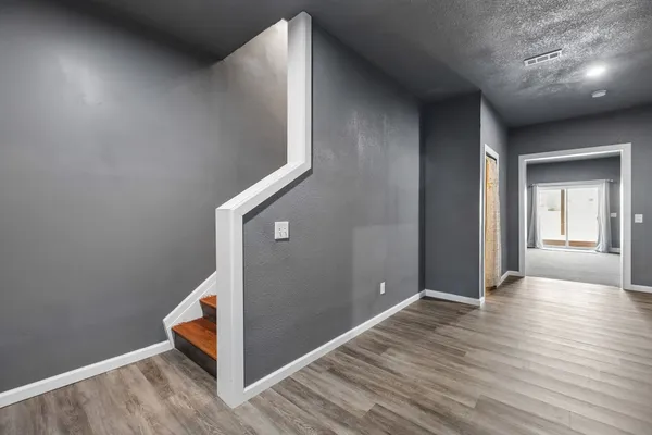 a spacious bedroom with a bed and a television