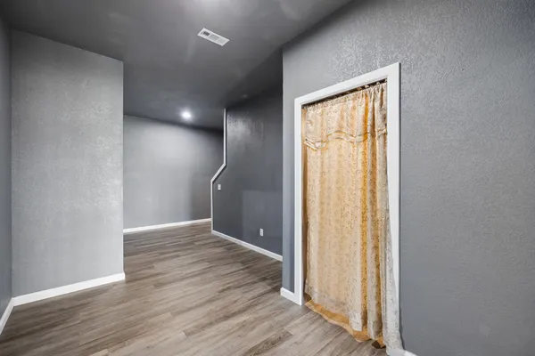 a bathroom with a sink a toilet and shower curtain