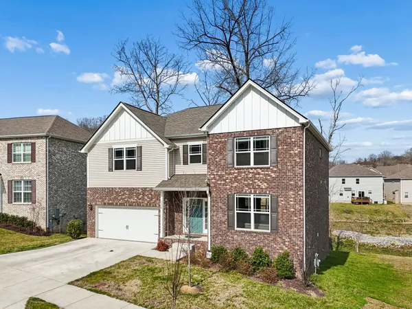 a front view of a house with a yard and garage
