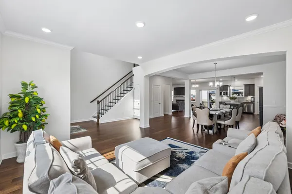 a living room with furniture and a window with wooden floor