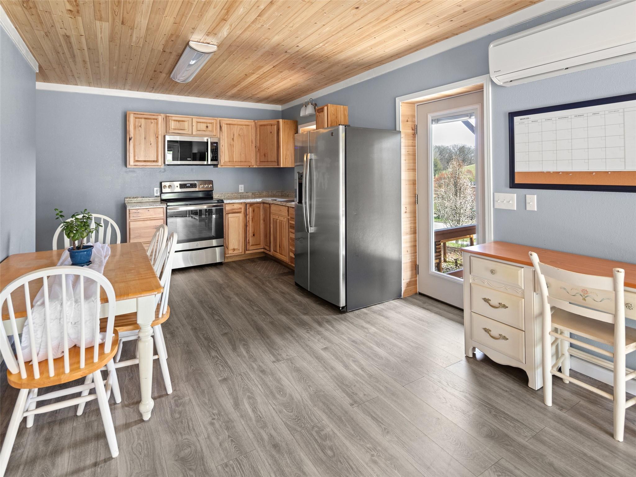 150 Barefoot Ridge Clyde, NC 28721 - Photo 14 of 27 a kitchen with stainless steel appliances a refrigerator and wooden floor