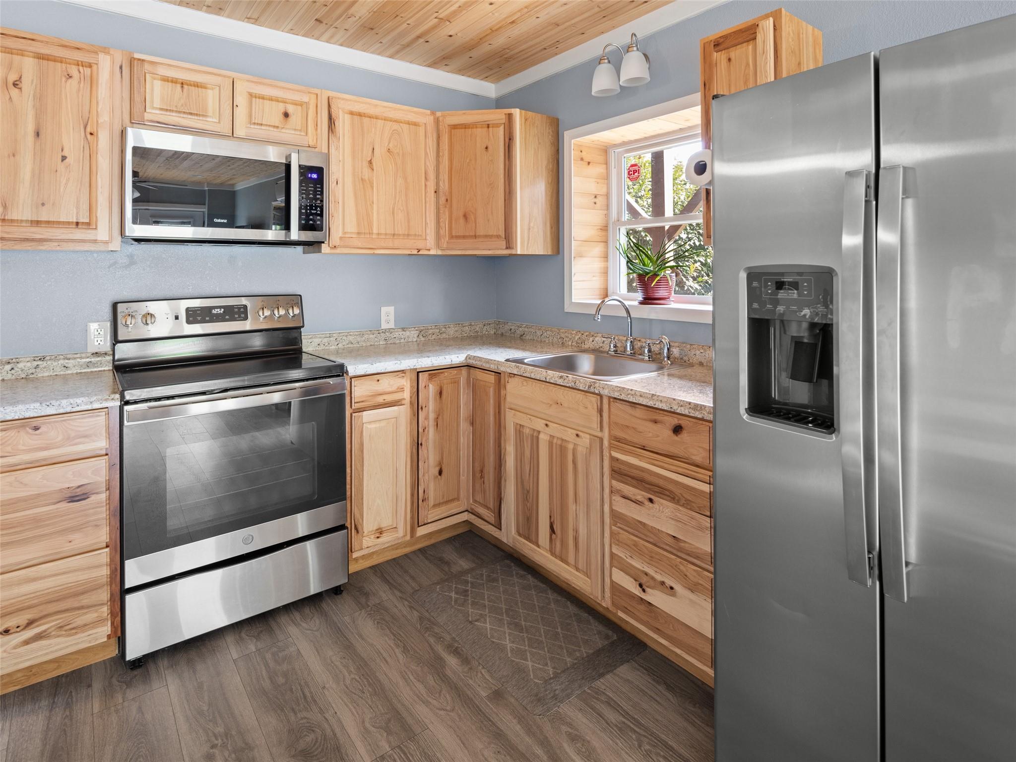 150 Barefoot Ridge Clyde, NC 28721 - Photo 16 of 27 a kitchen with stainless steel appliances granite countertop a stove a refrigerator and a microwave