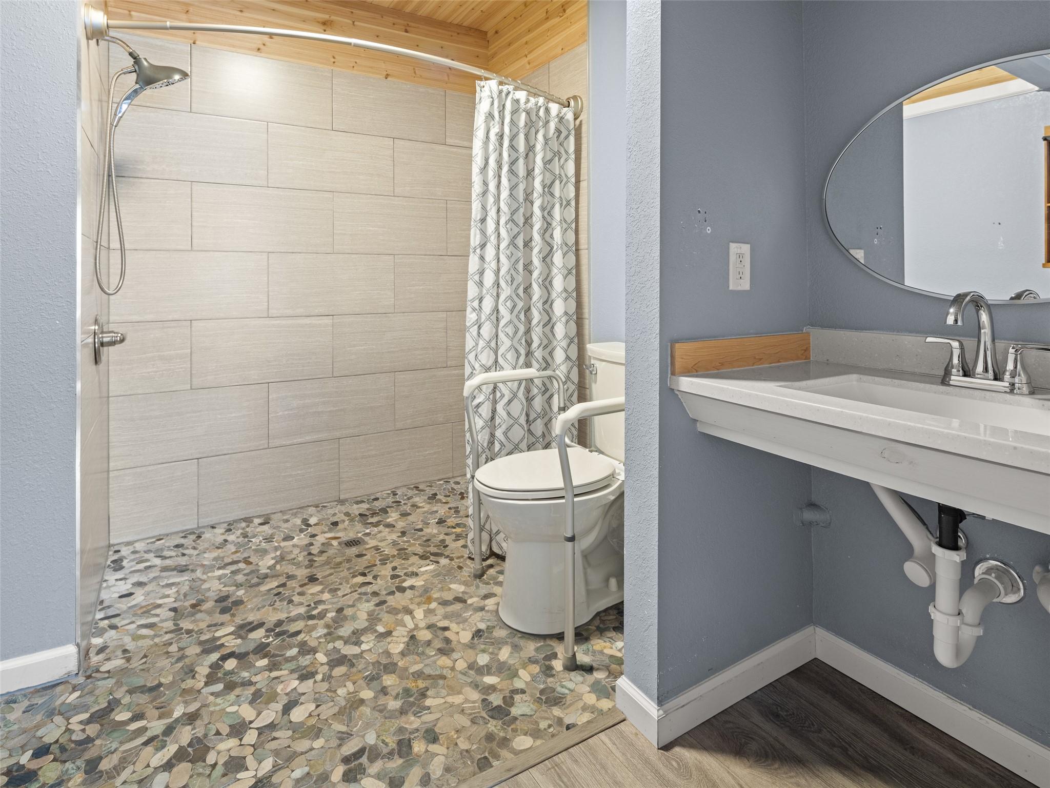 150 Barefoot Ridge Clyde, NC 28721 - Photo 19 of 27 a bathroom with a sink a toilet and shower