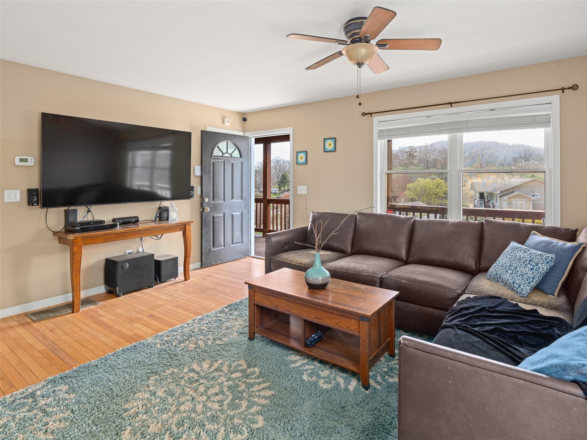 150 Barefoot Ridge Clyde, NC 28721 - Photo 4 of 27 a living room with furniture a flat screen tv and a fireplace