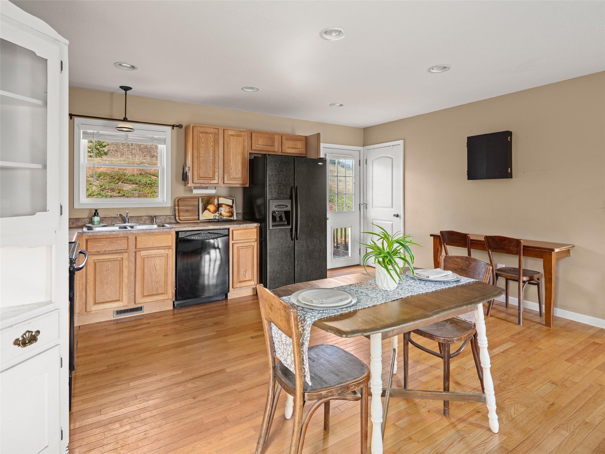 150 Barefoot Ridge Clyde, NC 28721 - Photo 7 of 27 a kitchen with a table chairs refrigerator and microwave