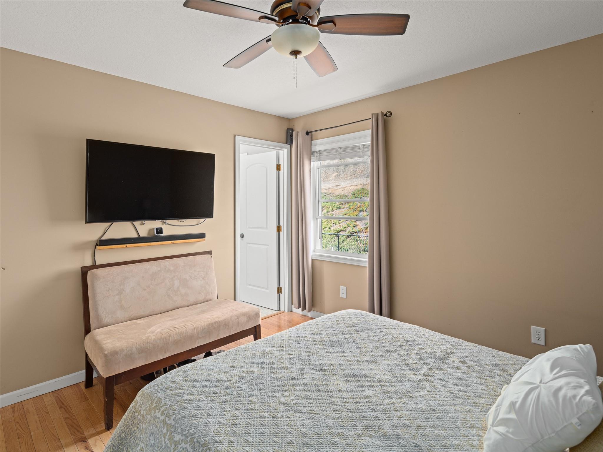 150 Barefoot Ridge Clyde, NC 28721 - Photo 8 of 27 a bedroom with a bed and a flat screen tv