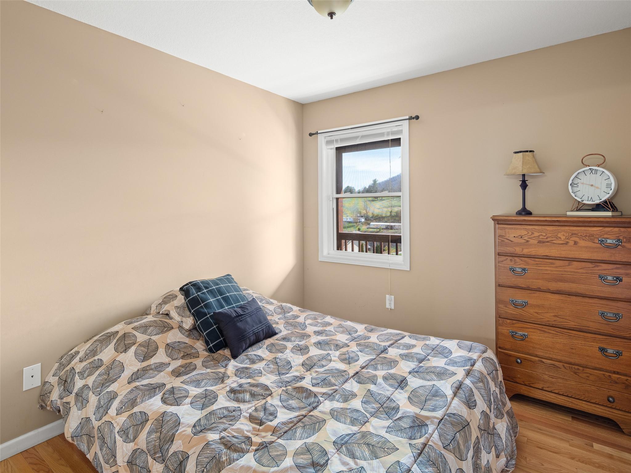 150 Barefoot Ridge Clyde, NC 28721 - Photo 10 of 27 a bedroom with a bed and a window