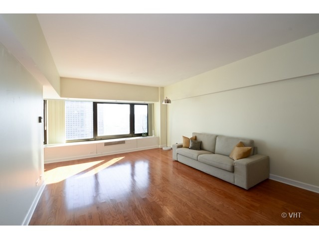 175 East Delaware Place, Unit 4522 Chicago, IL 60611 - Photo 3 of 15 a living room with furniture and a large window