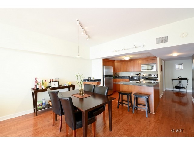 175 East Delaware Place, Unit 4522 Chicago, IL 60611 - Photo 7 of 15 a dining room with furniture and a kitchen view