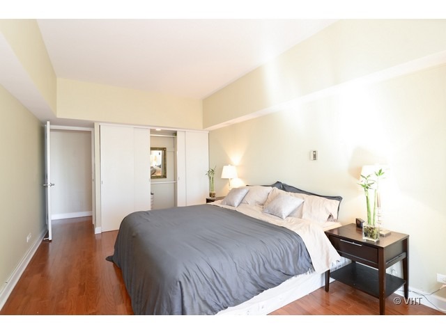 175 East Delaware Place, Unit 4522 Chicago, IL 60611 - Photo 9 of 15 a bedroom with a bed and a table