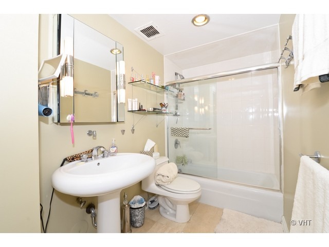 175 East Delaware Place, Unit 4522 Chicago, IL 60611 - Photo 10 of 15 a bathroom with a sink toilet a mirror and shower