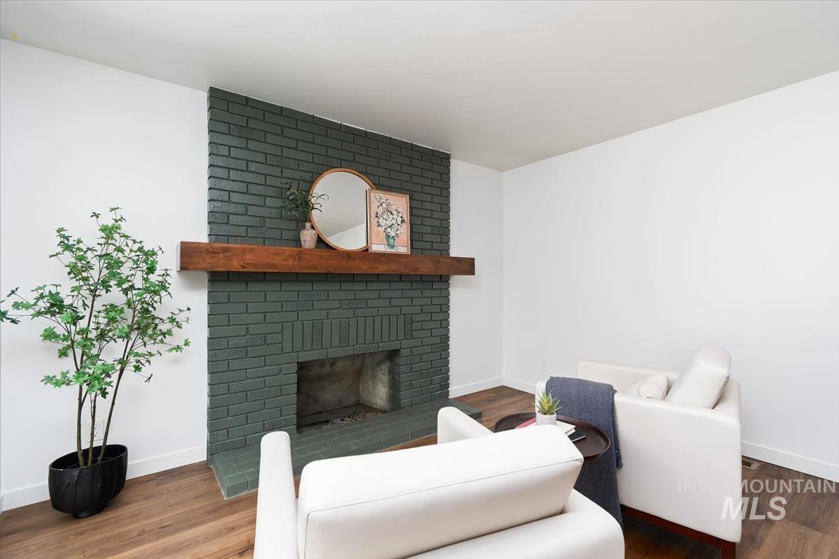 2217 North Middlefield Road Boise, ID 83704 - Photo 20 of 34 Fireplace featuring painted brick, a substantial wood mantel, and a firebox opening