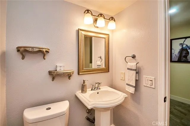 a bathroom with a sink a mirror and a toilet