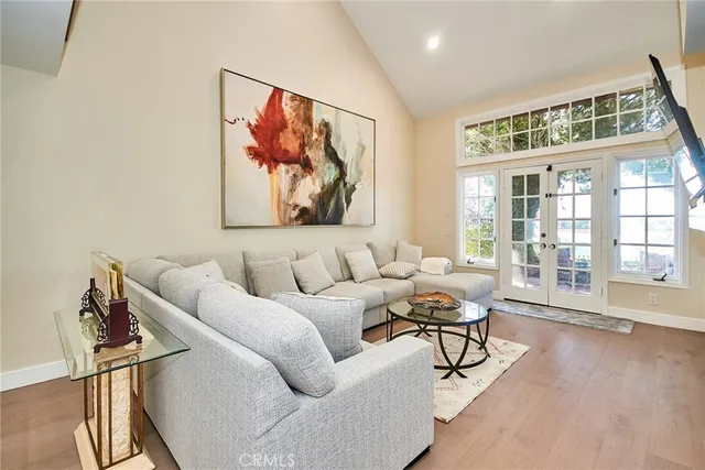 a living room with furniture and floor to ceiling window