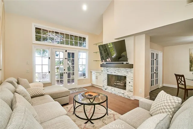 a living room with furniture a flat screen tv and a fireplace