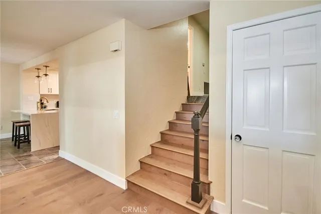 a view of a hallway with wooden floor and entryway