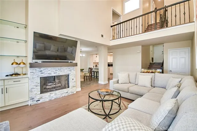 a living room with furniture a flat screen tv and a fireplace