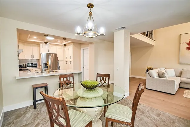 a view of a dining room with furniture and chandelier