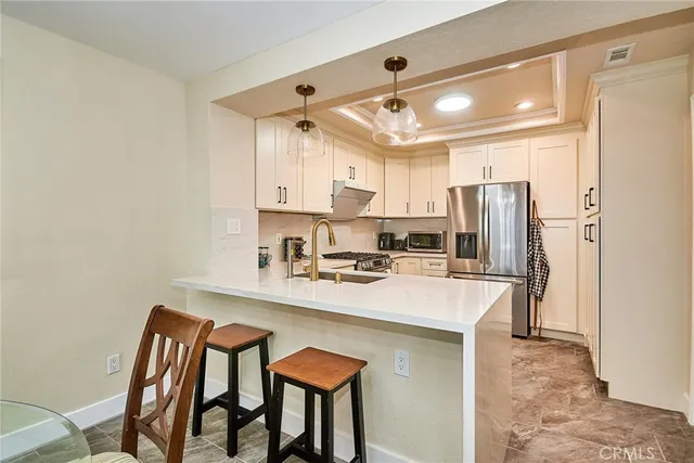 a kitchen with stainless steel appliances a sink and a refrigerator