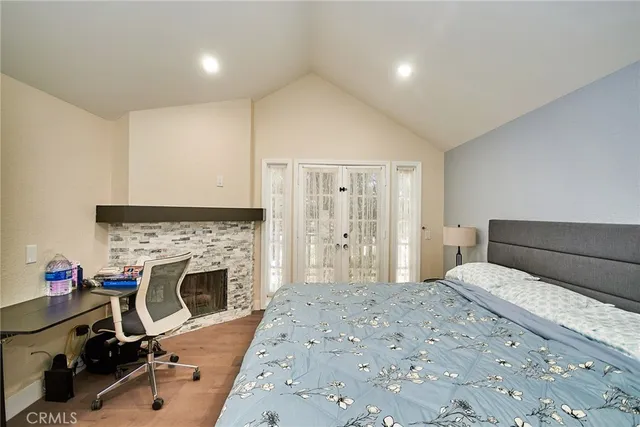 a bedroom with a bed and a fireplace