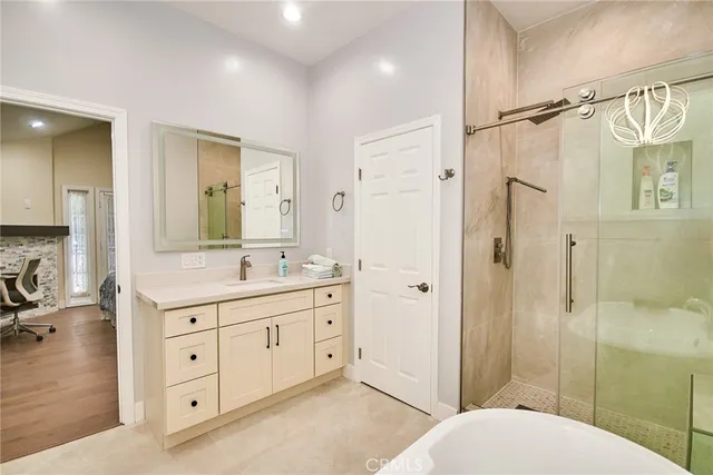 a spacious bathroom with a shower sink and a mirror