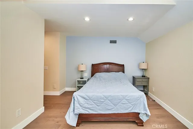 a bedroom with a bed and a lamp