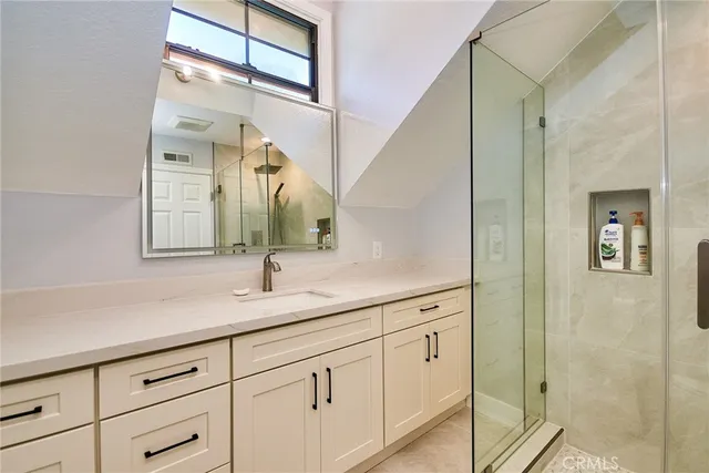 a bathroom that has a glass shower door
