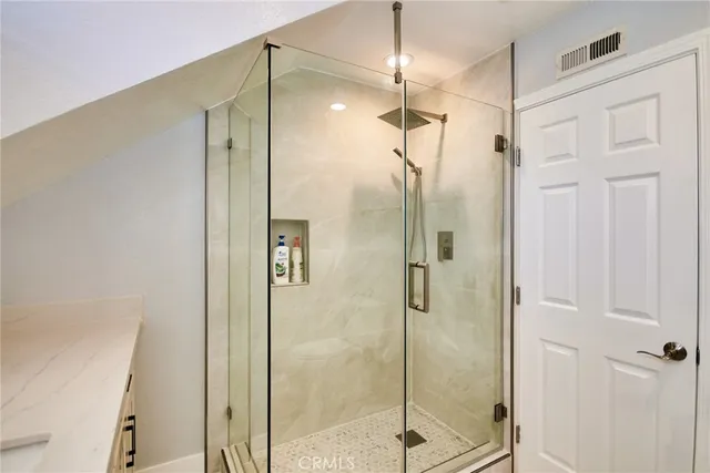 a bathroom with a shower and a sink