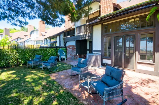 a view of a house with backyard porch and sitting area