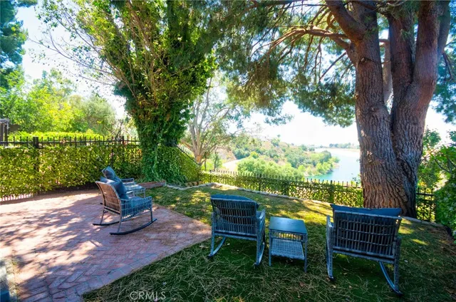 a view of a patio with a table and chairs under an umbrella