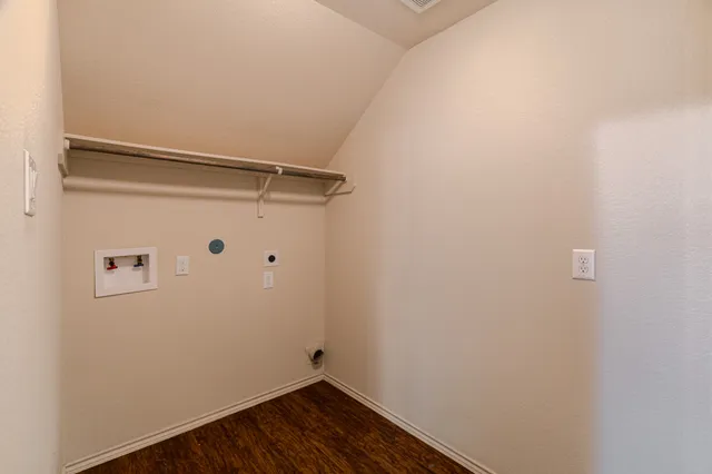 an empty room with windows and chandelier fan