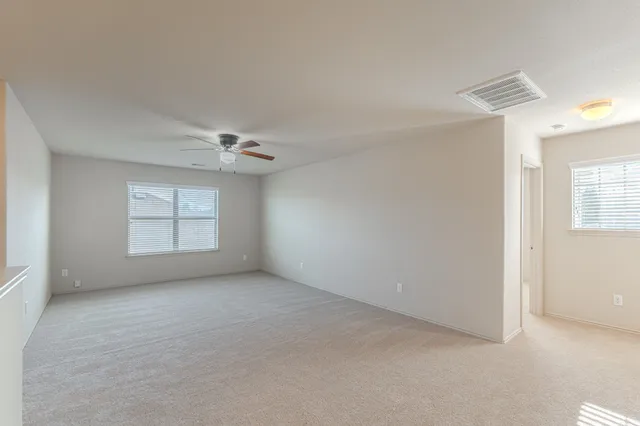 a view of a livingroom with a ceiling fan and a chandelier fan