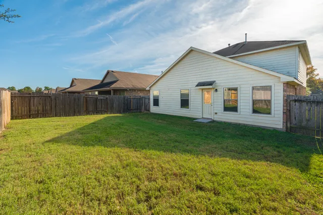 a view of a back yard of the house with green space