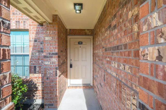 a view of a brick house with a street