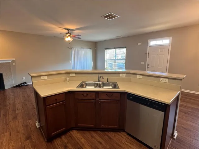 a view of a kitchen sink cabinets and wooden floor