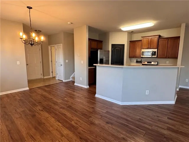 a view of kitchen with sink microwave and refrigerator