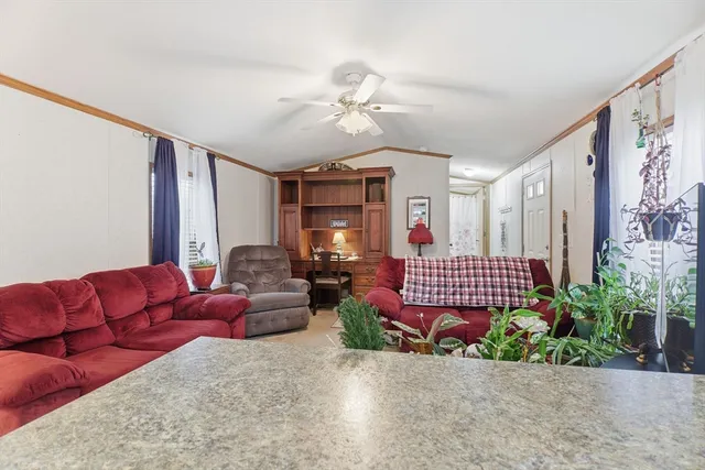 a living room with furniture and flowers