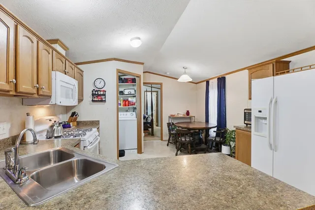 a kitchen with a refrigerator and a sink