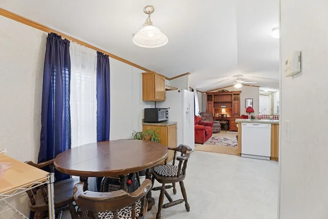 a view of a dining room with furniture and a chandelier