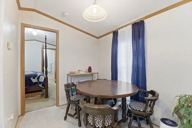 a view of a dining room with furniture and a potted plant