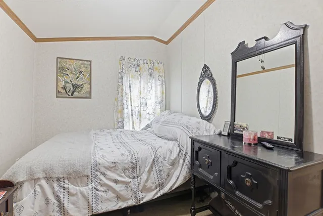 a bedroom with a bed and a table in it