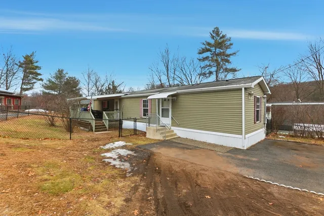 a view of a house with a yard and garage