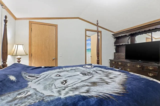 a bedroom with a bed and a flat screen tv