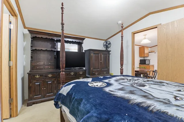 a bedroom with a bed and a mirror