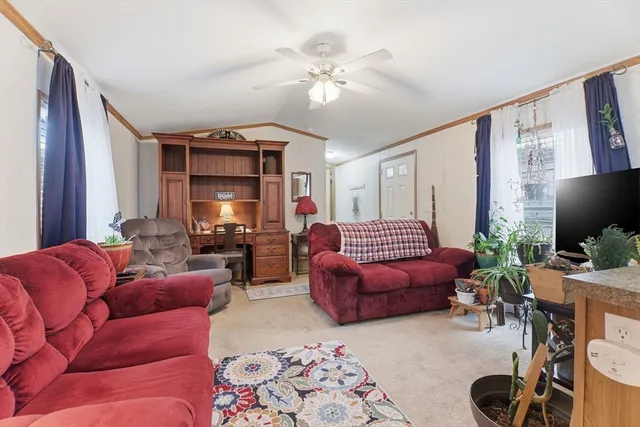 a living room with furniture and a chandelier