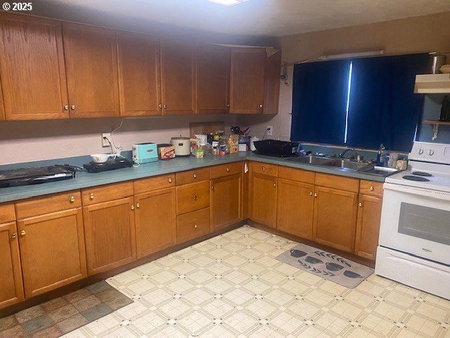7858 Nonpareil Road Sutherlin, OR 97479 - Photo 9 of 14 a kitchen with a sink stove and cabinets
