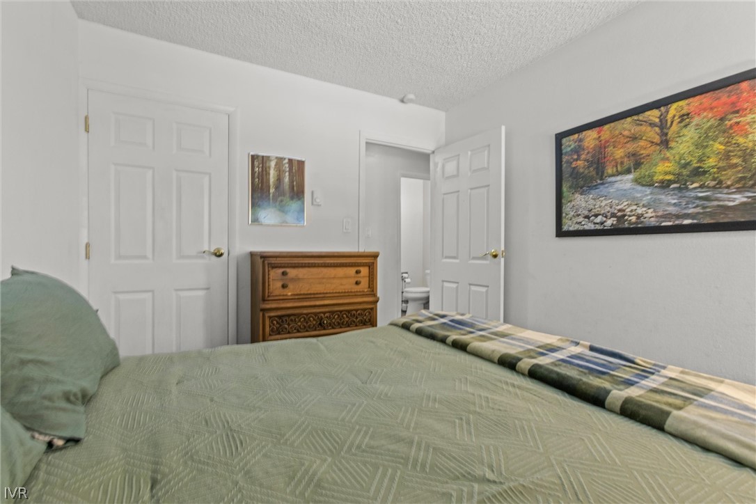 321 Ski Way, Unit 13 Incline Village, NV 89451 - Photo 14 of 26 a bedroom with a bed and a painting on the wall