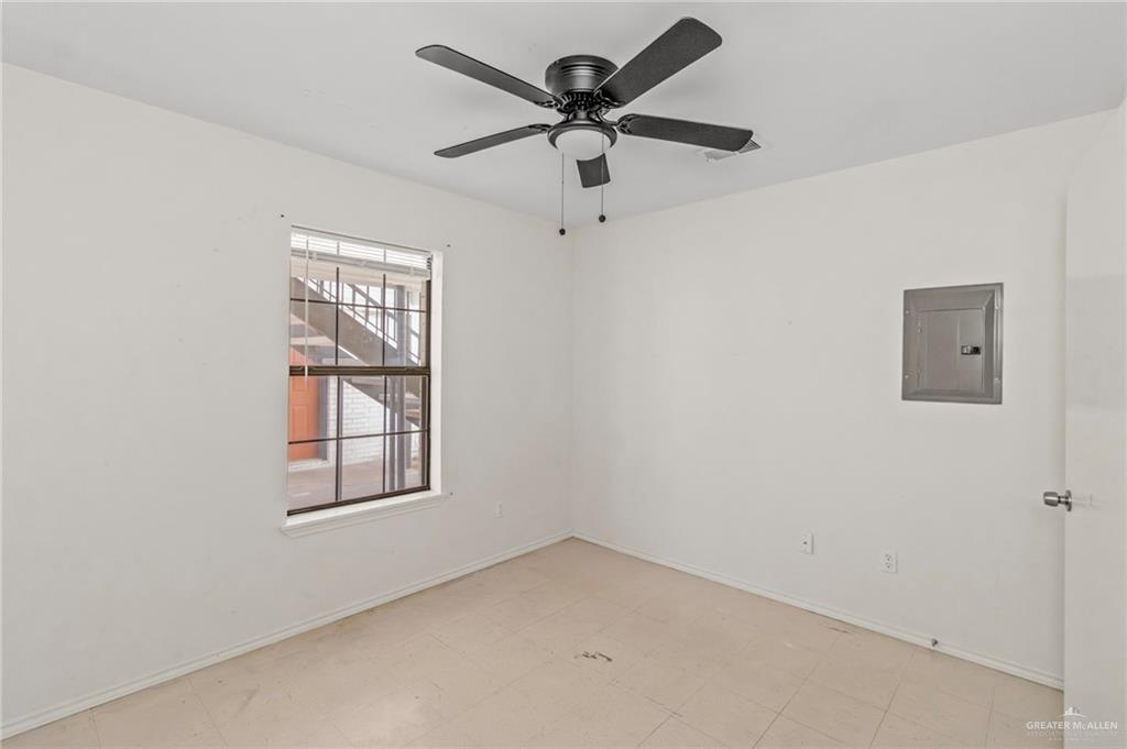 4601 South 24th Street, Unit 7 McAllen, TX 78503 - Photo 5 of 7 Unfurnished room featuring electric panel, a ceiling fan, and tile patterned floors