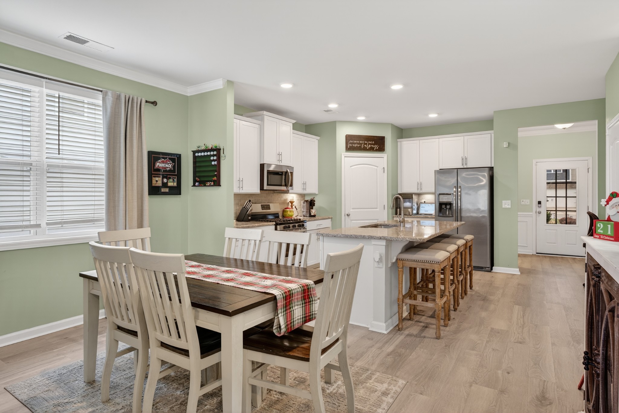 306 William Dylan Drive Murfreesboro, TN 37129 - Photo 13 of 47 a dining area with stainless steel appliances kitchen island granite countertop a dining table chairs and a refrigerator